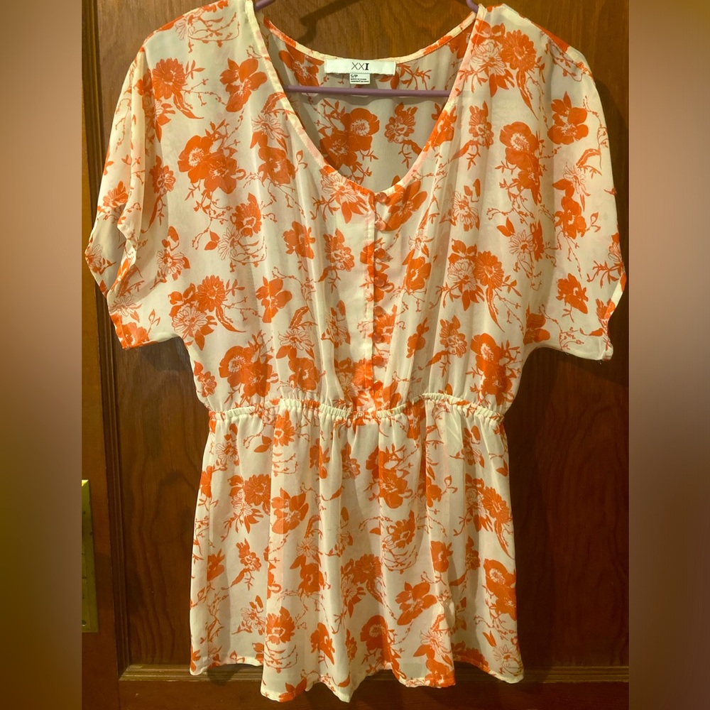 Sheer coral and white floral blouse.